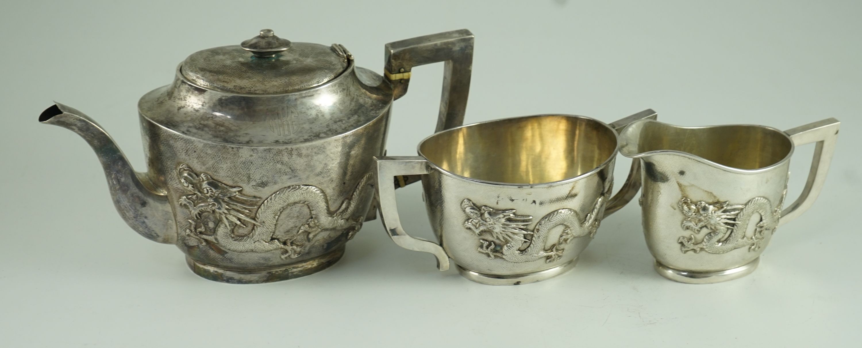 An early 20th century Chinese Export three piece silver tea set and matching silver inlaid hardwood two handled tea tray, by Luen Hing?